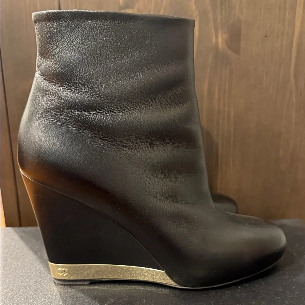 CHANEL Black Leather Wedge Boots with Gold Accent